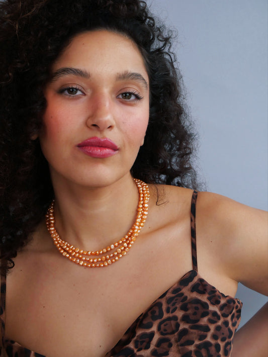 Curled hair model  leopard shirt peachy pearl 14K gold necklace