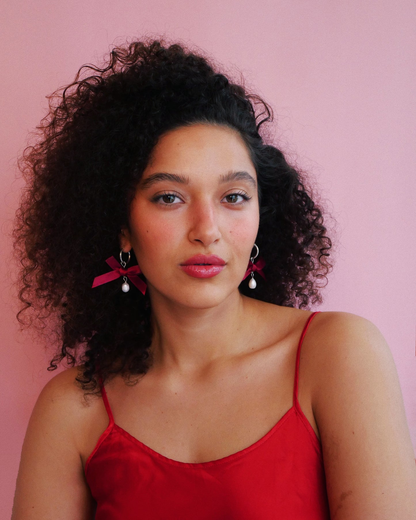 Curled hair model  red silk shirt white red velvet bow and white pearl 14K gold  earrings 